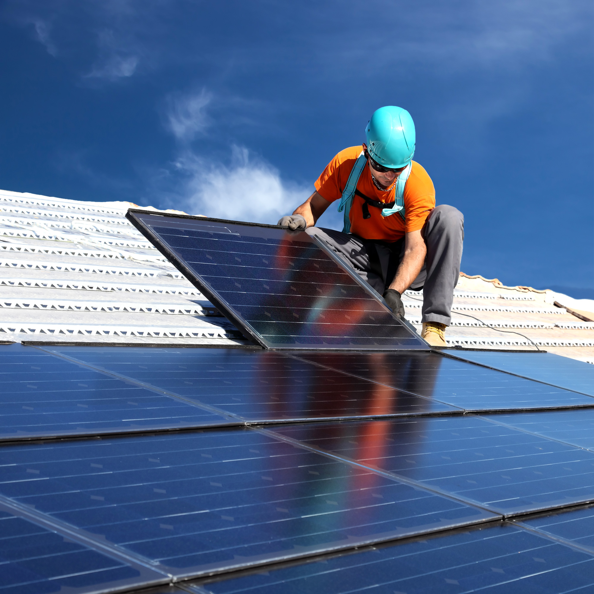 installing-alternative-energy-photovoltaic-solar-panels-on-roof